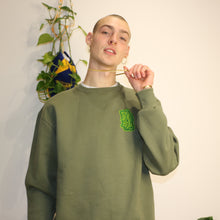 Load image into Gallery viewer, Green heavyweight sweatshirt featuring embroidered Manifest x Friends of Montys logo, combining comfort and style.
