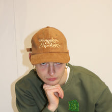 Load image into Gallery viewer, Brown cord cap with embroidered Manifest x Friends of Montys logo, blending style and collaboration