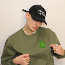 Load image into Gallery viewer, Bold green sweatshirt with intricate Manifest x Friends of Montys embroidery, perfect for cozy, casual wear.