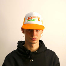 Load image into Gallery viewer, Stylish orange Manifest trucker hat with bold flower embroidery, perfect for a fun and casual look.