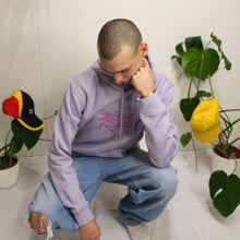 Load image into Gallery viewer, Stylish lavender hoodie with embroidered Manifest x Friends of Montys logo, ideal for fashion-forward individuals.