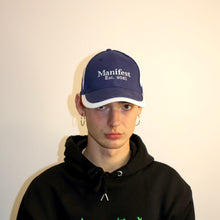 Load image into Gallery viewer, Navy baseball cap from Manifest featuring detailed embroidery, adding a sleek and stylish accessory to your look.