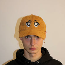 Load image into Gallery viewer, Manifest suede brown cap with intricate anime eyes embroidery, offering a unique and stylish look
