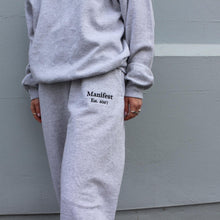 Load image into Gallery viewer, Stylish grey Manifest joggers with embroidered accents, perfect for everyday wear and relaxed vibes