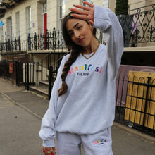 Load image into Gallery viewer, Grey sweatshirt featuring embroidered Manifest Pride design, celebrating inclusivity and individuality.