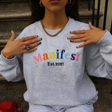 Load image into Gallery viewer, Grey Manifest sweatshirt with embroidered Pride flag design, designed for a fashionable and inclusive look.