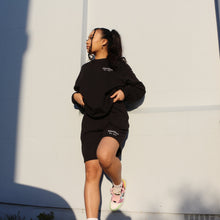 Load image into Gallery viewer, Classic black sweatshirt with bold Manifest embroidery, ideal for layering and making a fashion statement.