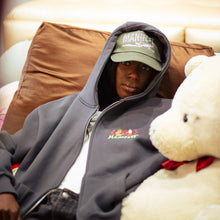 Load image into Gallery viewer, Person wearing a hoodie and cap sitting on a couch with a teddy bear
