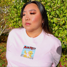 Load image into Gallery viewer, Person wearing a pink t-shirt with a cat cartoon design in an outdoor setting
