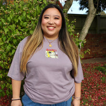Load image into Gallery viewer, Person wearing a purple t-shirt with a graphic smoking toad design outdoors
