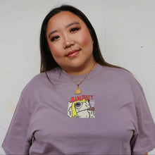 Load image into Gallery viewer, Person wearing a purple tshirt with a graphic toad on a plain background
