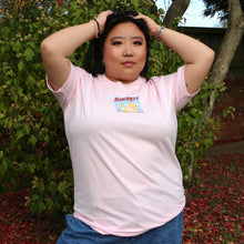 Load image into Gallery viewer, Person wearing a pink t-shirt with a cat graphic design outdoors
